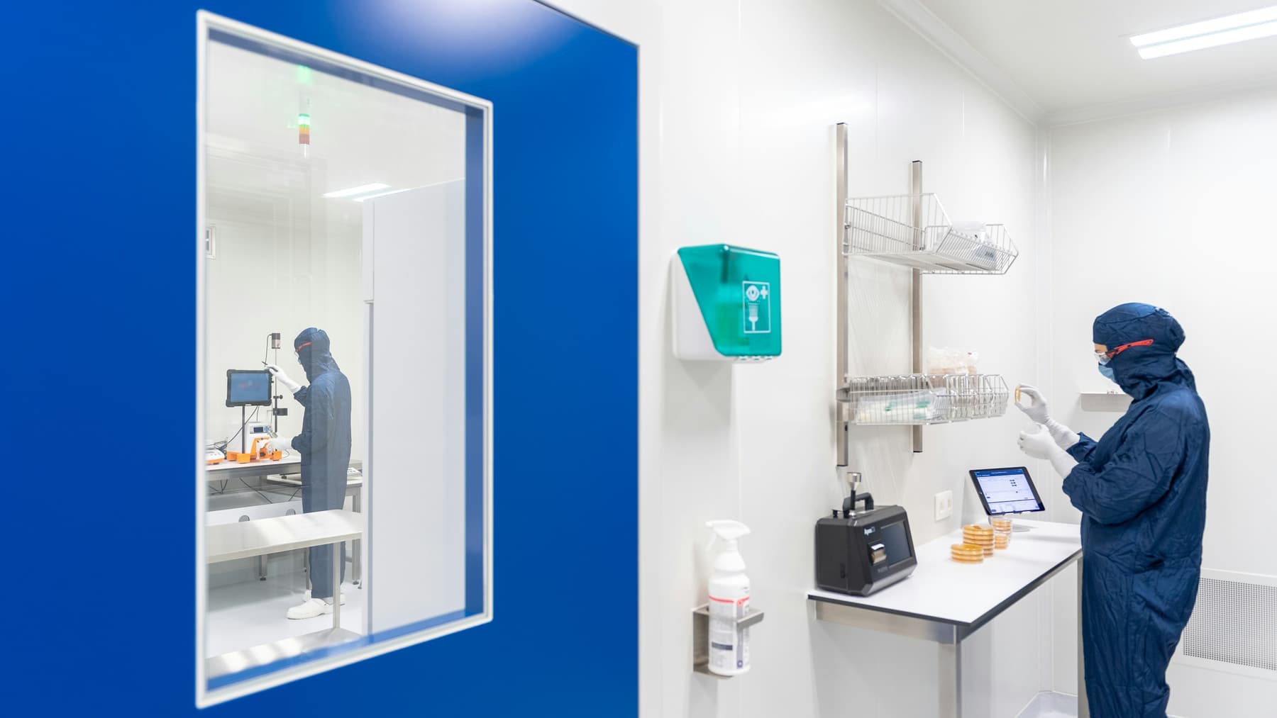 A compounding suite seen through the glass of its anteroom
