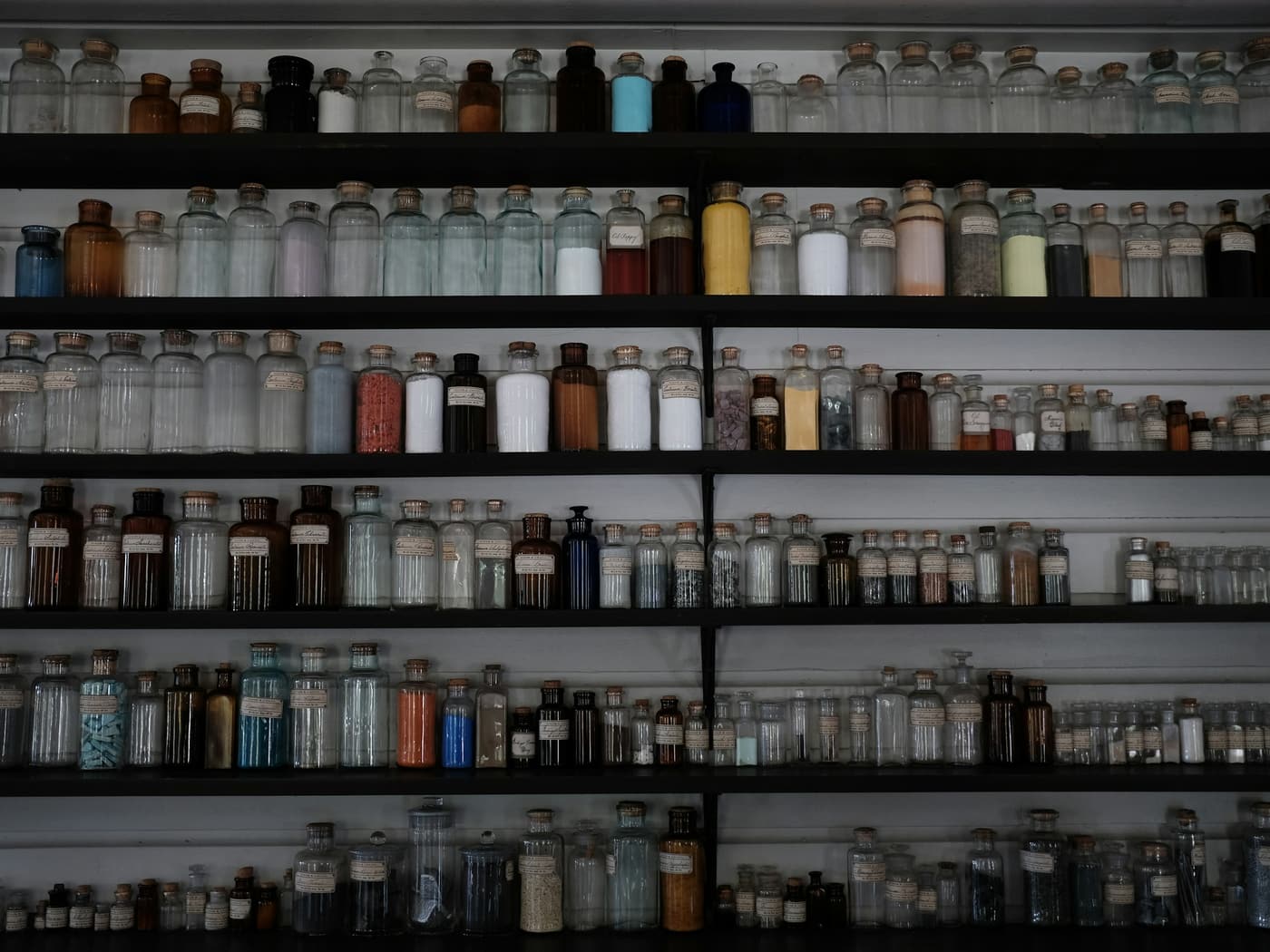A full wall of labelled stock bottles on steel shelving